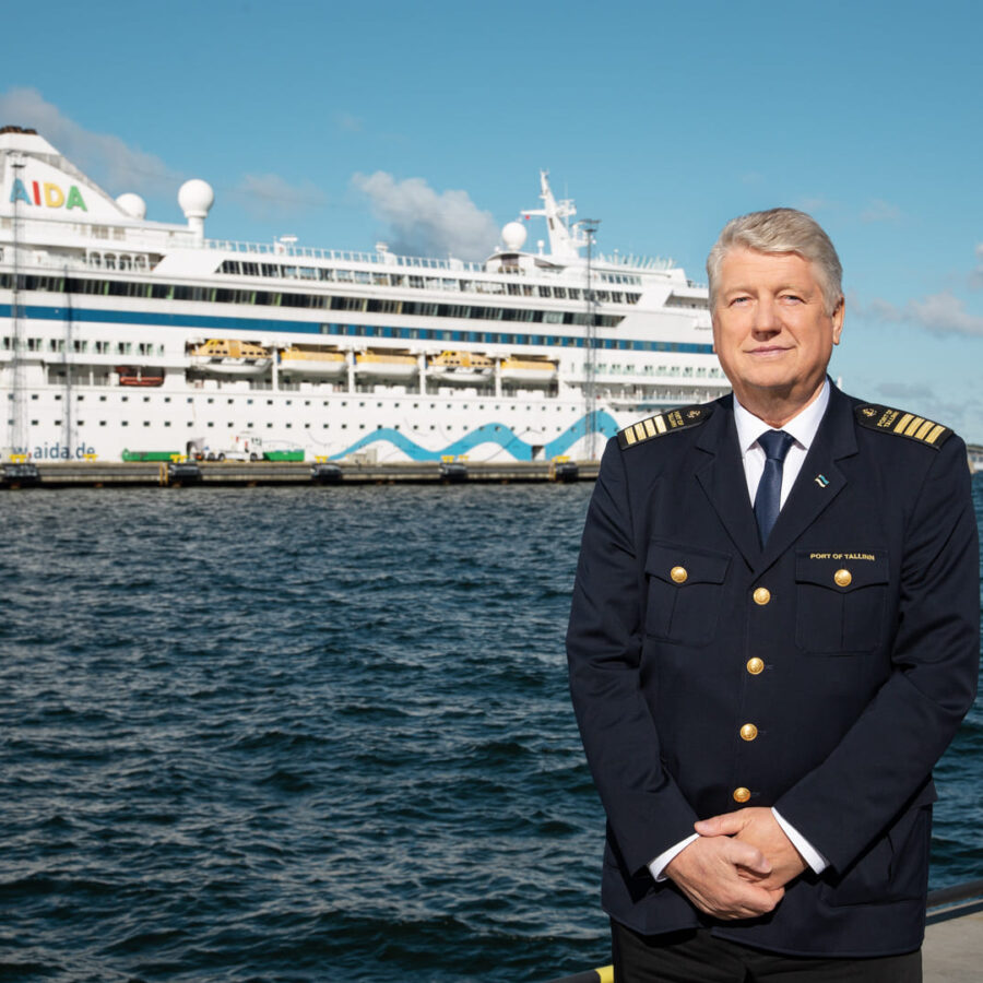 Chief Harbour Master of Tallinna Sadam in uniform by the waterfront, with a cruise ship in the background, symbolising leadership.